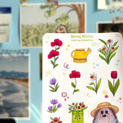Sticker sheet with spring-themed illustrations including flowers and a watering can, with a hedgehog character on a blue background.