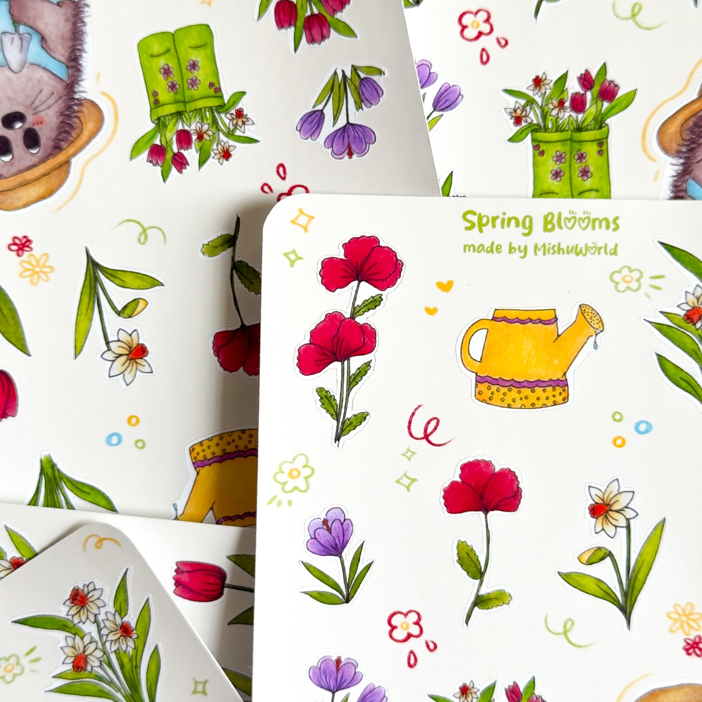 Spring-themed sticker sheets with flowers and gardening elements piled up.