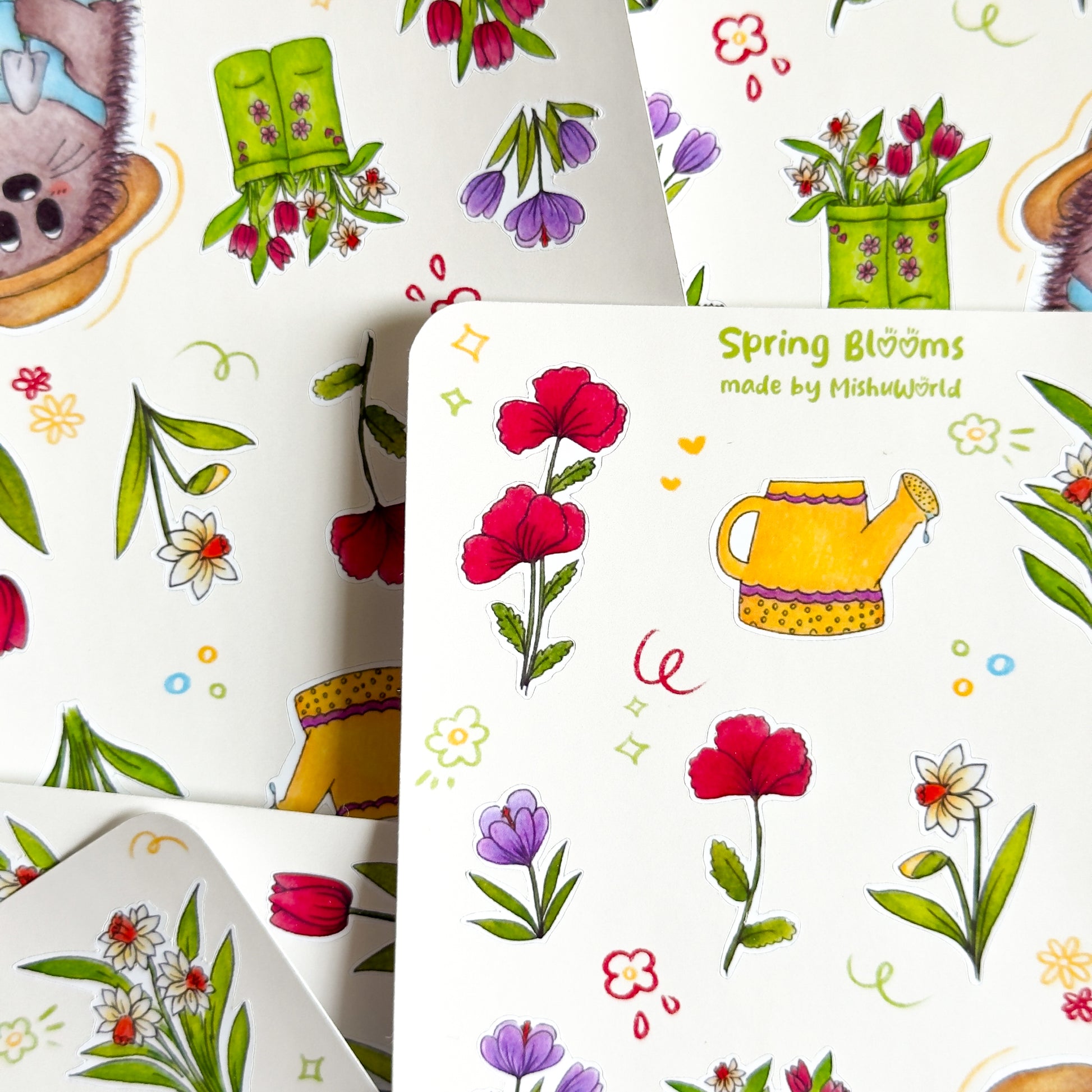 Spring-themed sticker sheets with flowers and gardening elements piled up.