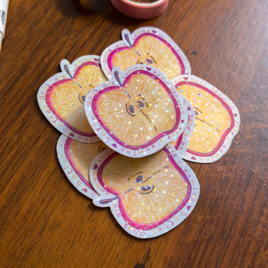 Stack of decorative apple-shaped cards on a wooden surface