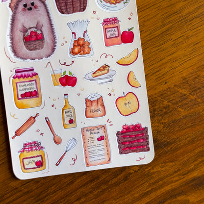 Sheet of decorative stickers featuring food and kitchen items on a wooden surface