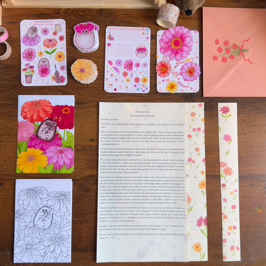 Collection of stationery items with floral designs on a wooden surface