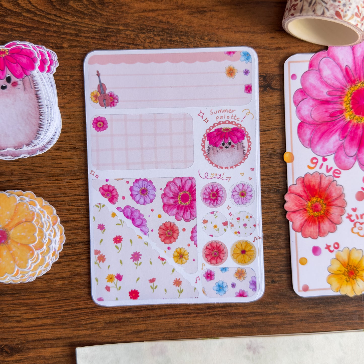 Floral-themed stationery items on a wooden surface