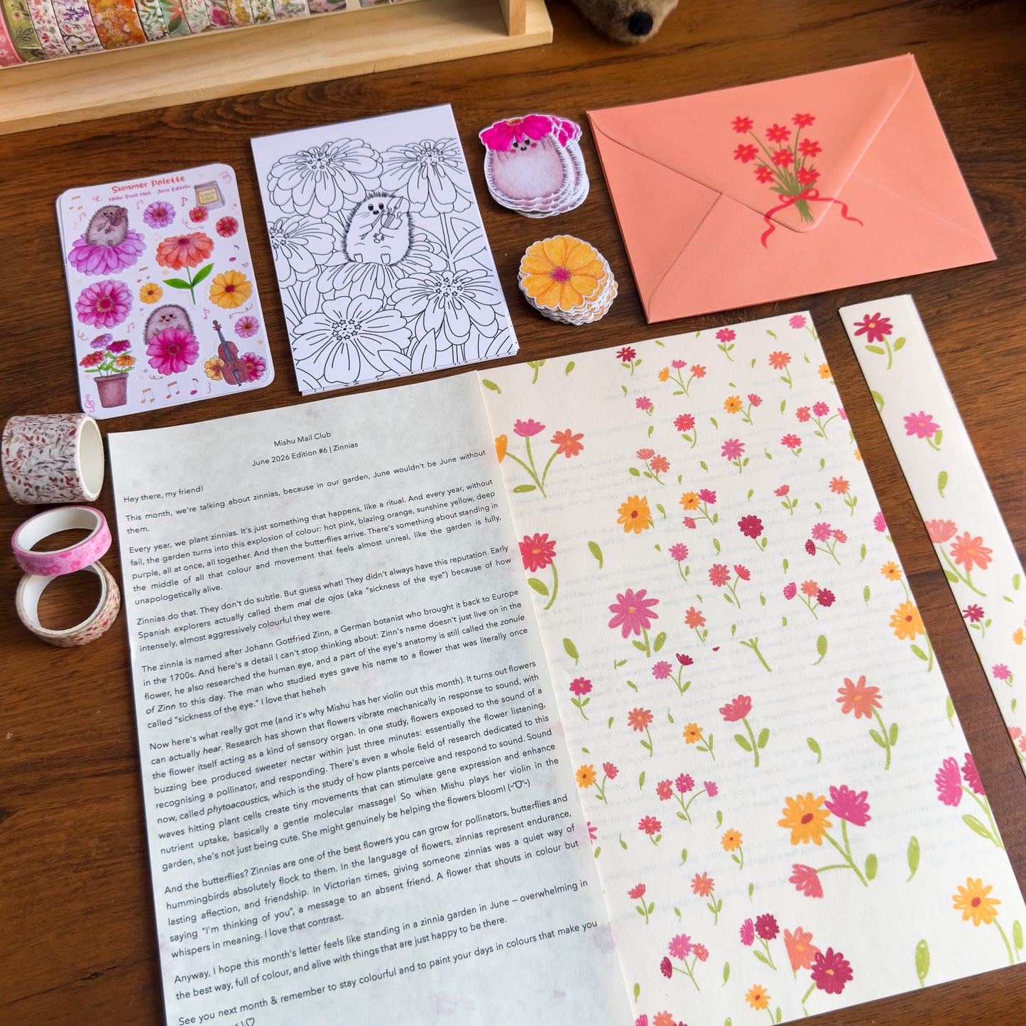 Floral stationery items including cards, envelopes, and stickers on a wooden surface.