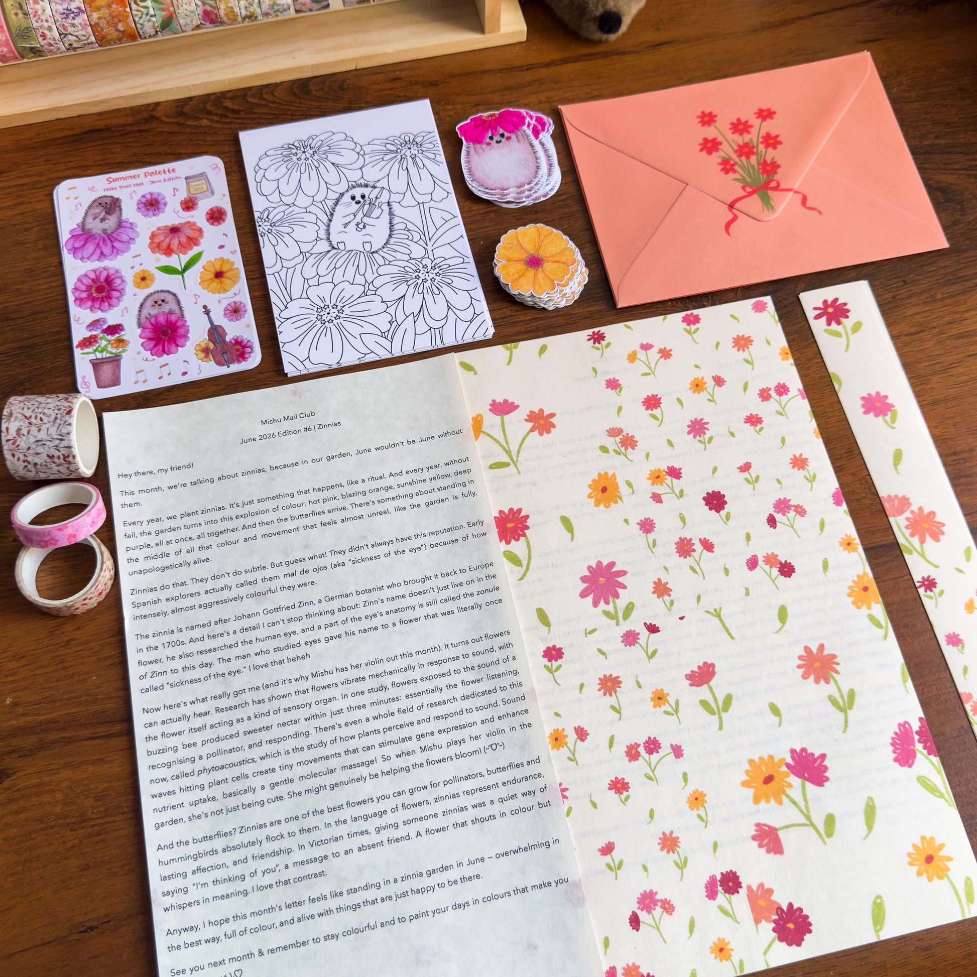 Floral stationery items including cards, envelopes, and stickers on a wooden surface.