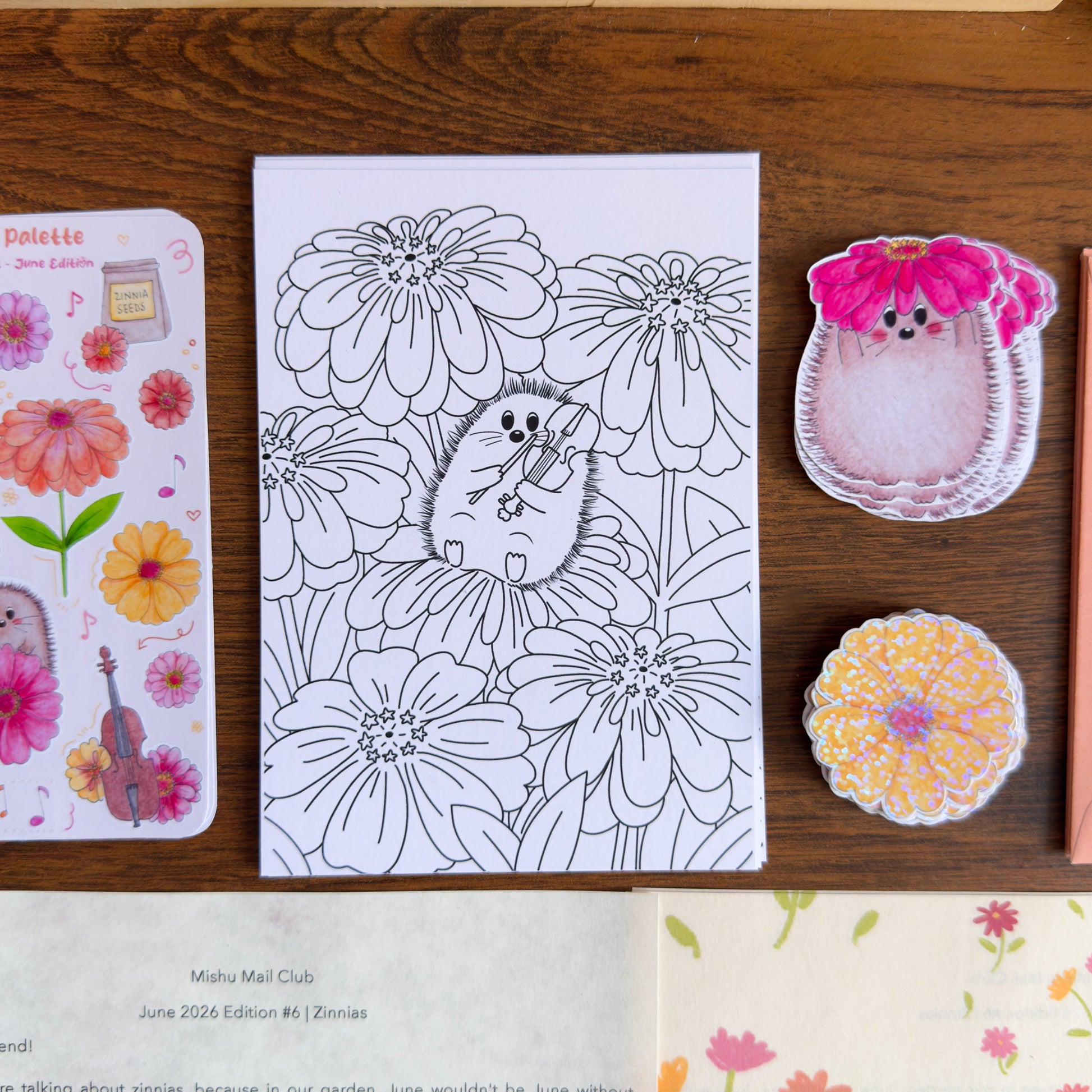 Coloring page with hedgehog and flower design on a wooden surface with decorative items.