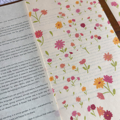 Floral patterned paper with a letter on a wooden surface