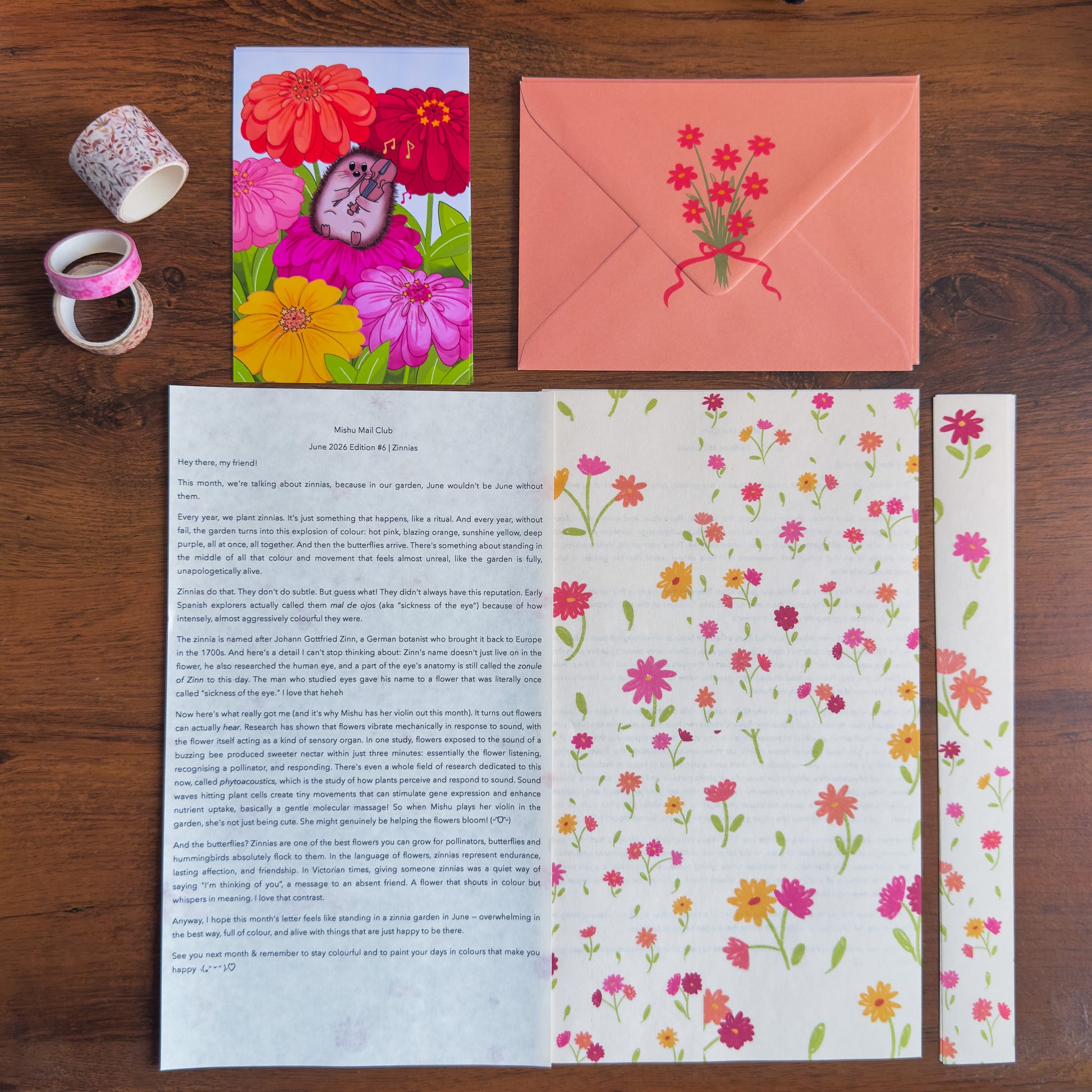 Floral stationery set with a card, envelope, and paper on a wooden surface.
