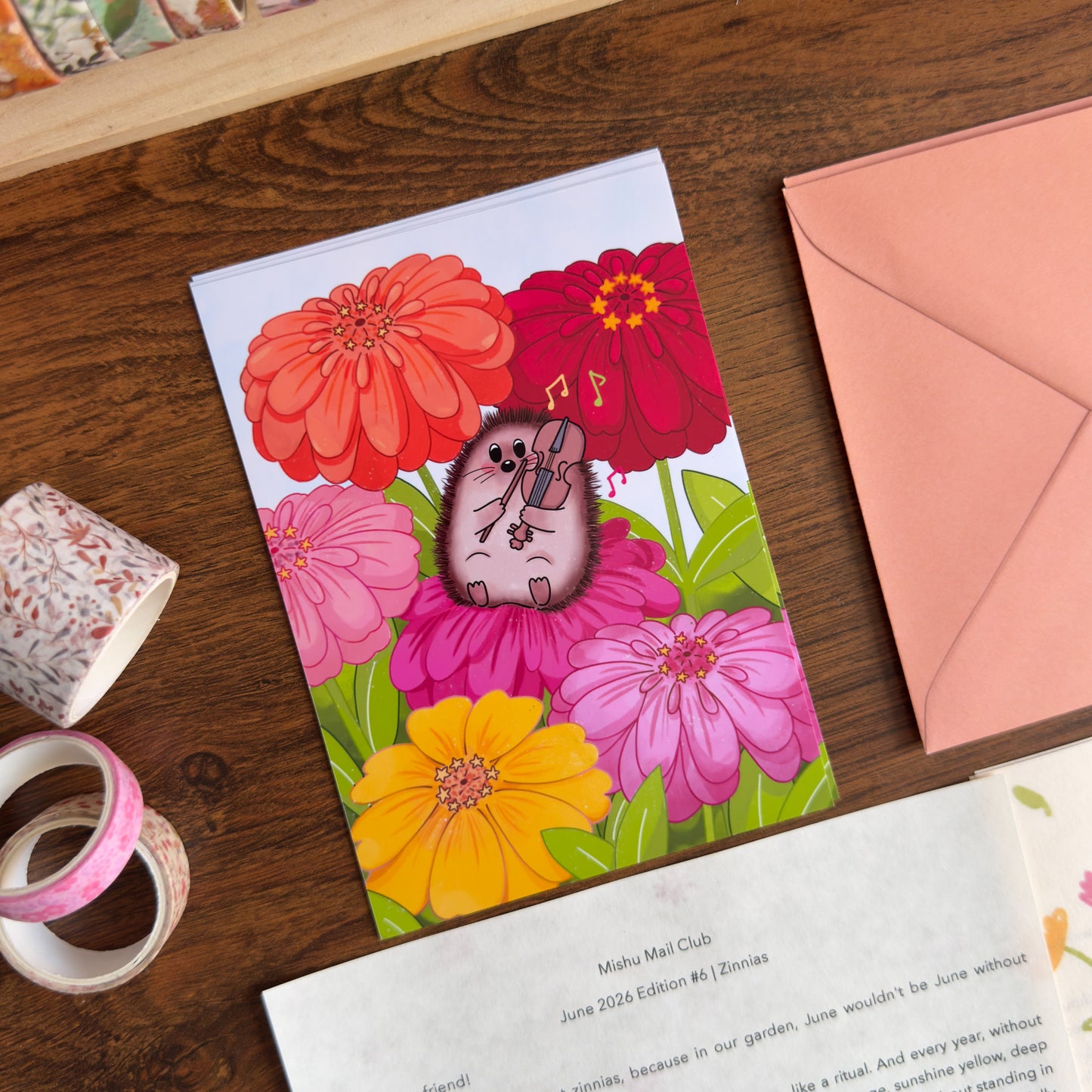 Colorful art print with a hedgehog playing a violin among flowers on a wooden surface.