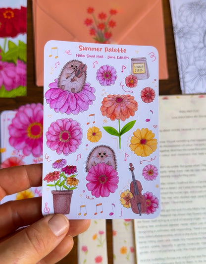 Sticker sheet with hedgehogs and flowers held by a hand against a colorful background.