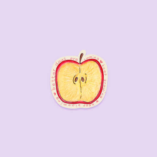 Sliced apple sticker with a motivational quote on a purple background