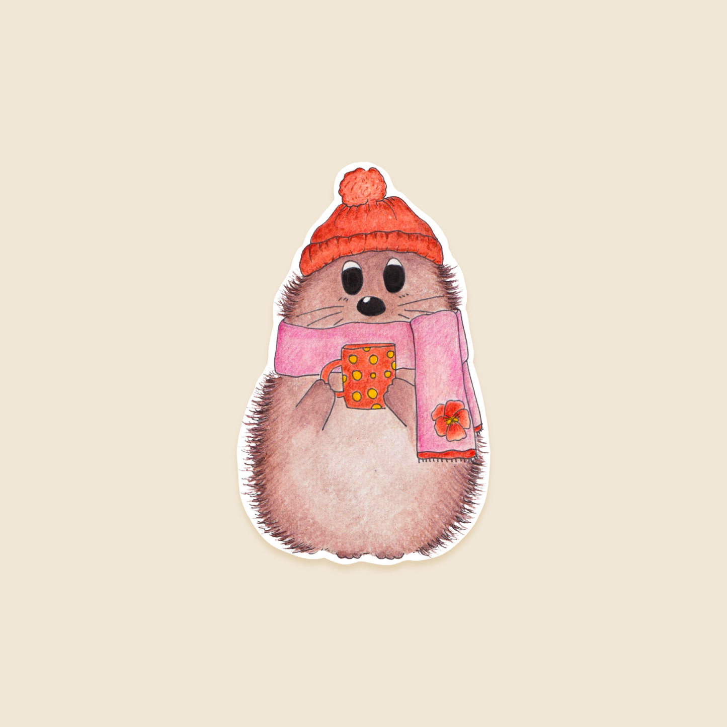 sticker of a hedgehog wearing a hat and scarf, holding a mug on a beige background